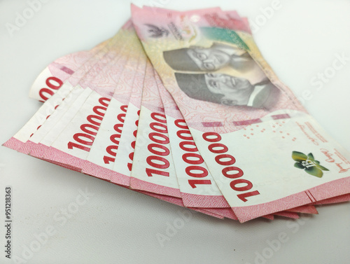 Close up One Hundred thousand Indonesian banknotes (Rupiah). Cash payment concept. Indonesian rupiah currency (Rp. 100,000 One Hundred Thousand Rupiah) on a white background