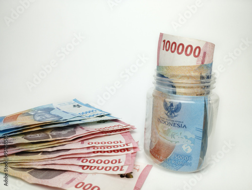 Various paper money of Indonesian rupiah. Concept of finance, investment, economy, business and success. Money in glass cup. Saving your money. Uang 10000 50000 Rupiah Indonesia