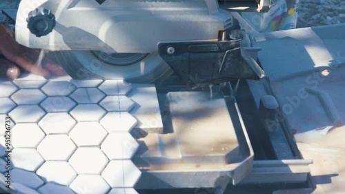 Tiler cutting the tile with a circular saw. The perfect tile-cutting blade for a circular saw when cutting porcelain tile is the diamond blade.