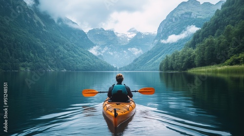 A person kayaking on a calm lake with mountains in the distance, capturing the essence of outdoor fitness and exploration with space for copy.