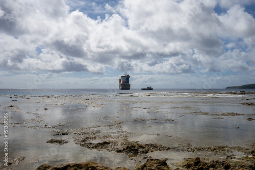 A cargo ship offloading supplies to the tropical island of Niue in the South Pacific