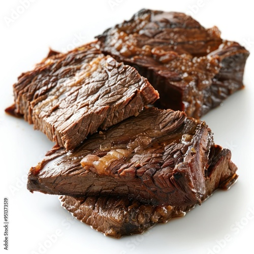 Cut-up steaks with a rich glaze over them, resting on a white plate. photo