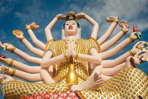 Wat Plai Laem Temple buddhist in Koh Samui Island Thailand tilt up of big buddha sculpture landmark photo