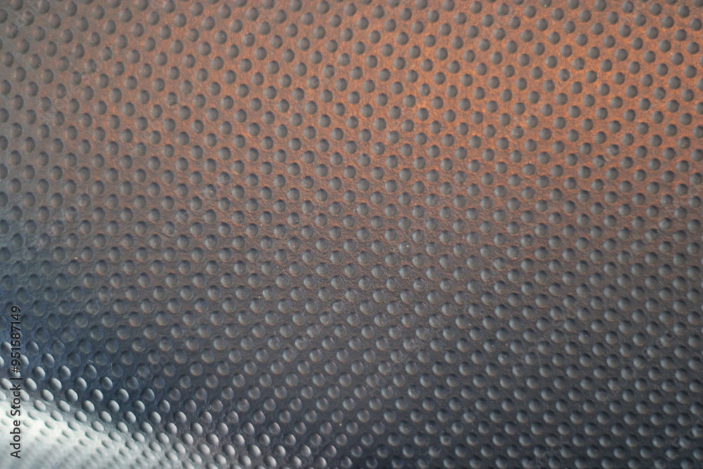 Close-up of a textured surface with a repeating pattern of raised circles.