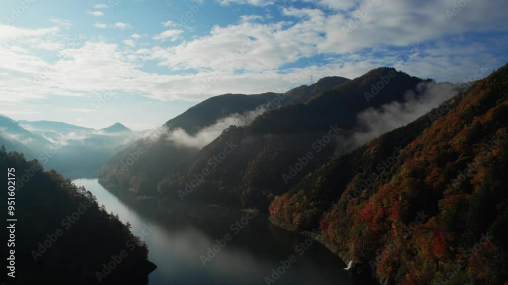 Aerial View of an Autumn-Colored Lake and Sunlit Mountains at Dawn Aerial View of an Autumn-Colored Lake and Sunlit Mountains at Dawn