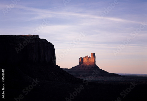 Arizona, USA - August 15, 2006: Summer and sunset view of shadow on the rock cliff with the background of a red one at Monument Valley