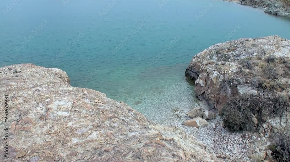 Experience tranquil beauty of secluded mountain lake in Patagonia, Argentina, where crystal waters meet rugged shores at twilight. Experience tranquil beauty of secluded mountain lake in Patagonia, Argentina, where crystal waters meet rugged shores at twilight.