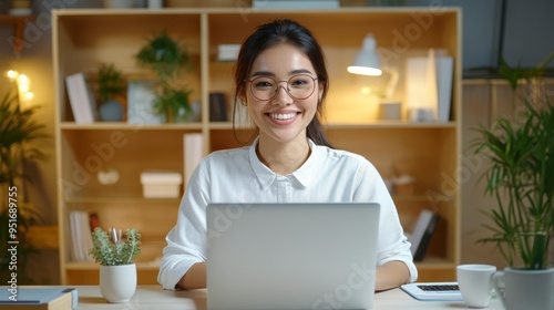 Remote Work, Smiling woman in glasses working on a laptop, Home Office Environment.