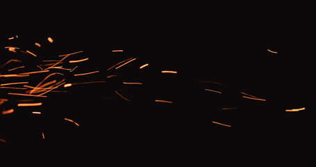 hot sparks floating from side on black background