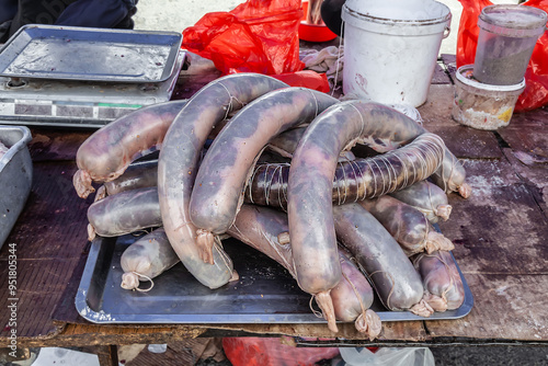 Kazy horse meat sausage lies on the table for sale photo