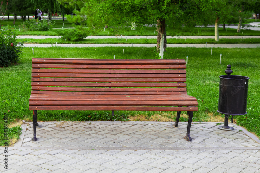 Empty bench in a city park. Background with copy space for text or lettering. Empty bench in a city park. Background with copy space for text or lettering.