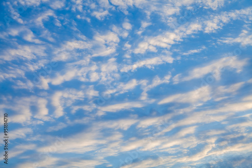 Sun shining through the puffy clouds. Sky view. Beautiful sunny sky. Background with clouds on blue sky. Clouds on blue sky.