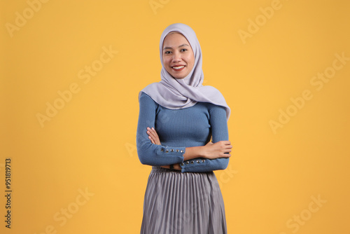 Canvastavla portrait of asian indonesian muslim woman on isolated yellow background