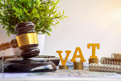 Stacking coins and gavel hammer with financial concept. tax vat law