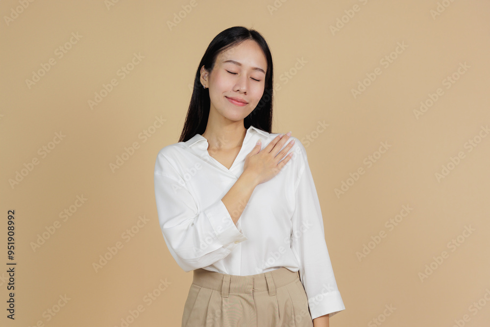 Grateful Woman with Hand on Heart, Expressing Thanks, Beige Background Grateful Woman with Hand on Heart, Expressing Thanks, Beige Background