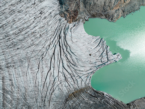 Aerial view of the Fellaria glacier in Valmalenco, Sondrio, Lombardy. Italy. Ice cliff, rock face with waterfalls and lake. Marson glaciological trail. Climate change, melting glaciers photo