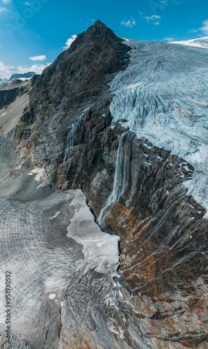 Aerial view of the Fellaria glacier in Valmalenco, Sondrio, Lombardy. Italy. Ice cliff, rock face with waterfalls and lake. Marson glaciological trail. Climate change, melting glaciers photo