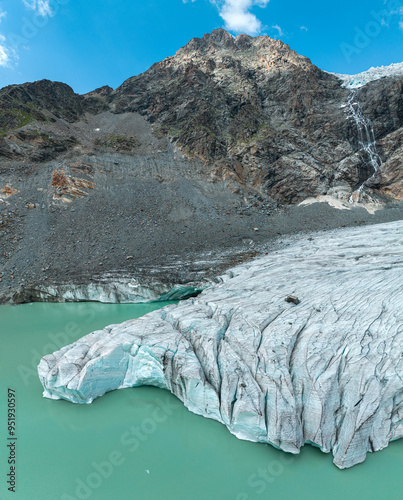 Aerial view of the Fellaria glacier in Valmalenco, Sondrio, Lombardy. Italy. Ice cliff, rock face with waterfalls and lake. Marson glaciological trail. Climate change, melting glaciers photo