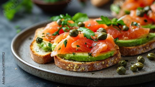 Bruschetta with avocado, smoked salmon, and capers on a rustic ceramic plate