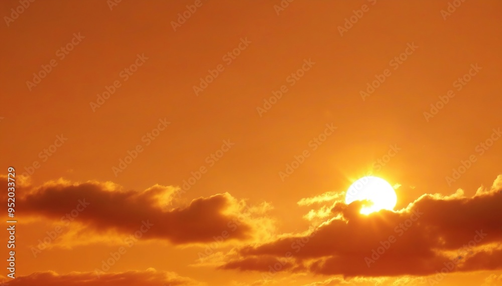 Fototapeta premium Orange sky with sun and clouds during hot summer weather