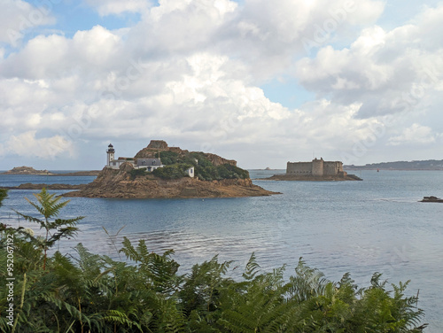 The lighthouse of Île Louët with Château du Taureau (Taureau Fort) in the background in the bay of Morlaix, Bretagne (Brittany), France photo