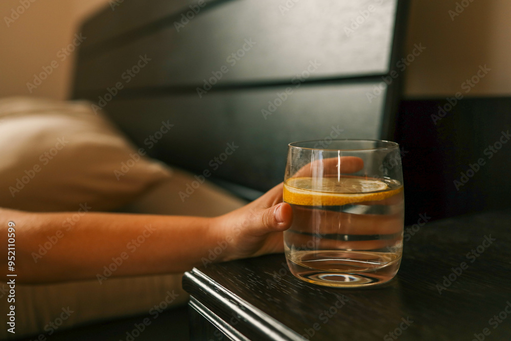 Close up of woman's hand taking a glass of water Close up of woman's hand taking a glass of water