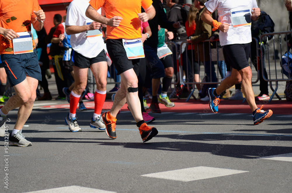 Marathon running race, many runners feet on road racing, sport competition, fitness and healthy lifestyle concept Marathon running race, many runners feet on road racing, sport competition, fitness and healthy lifestyle concept