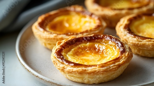 Freshly baked pastry, golden brown crust, creamy custard filling, Portuguese egg tart, flaky layers, caramelized top, soft and gooey center, mouth-watering dessert, food photography.