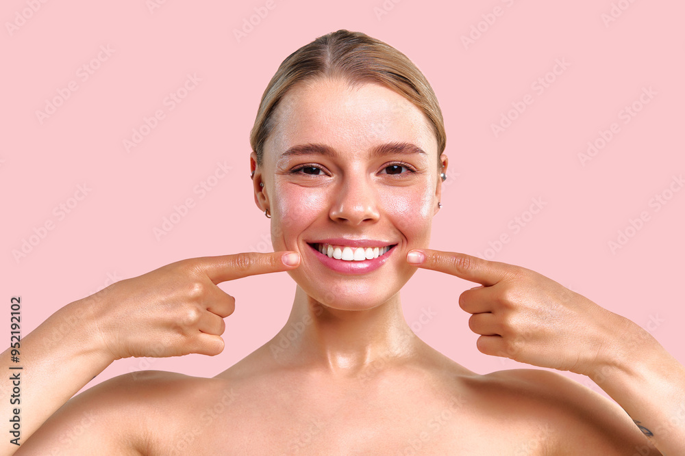 Portrait on a soft pink background of a beautiful young woman showing her beautiful snow-white smile. Dental care. Teeth whitening and check-up. Portrait on a soft pink background of a beautiful young woman showing her beautiful snow-white smile. Dental care. Teeth whitening and check-up.