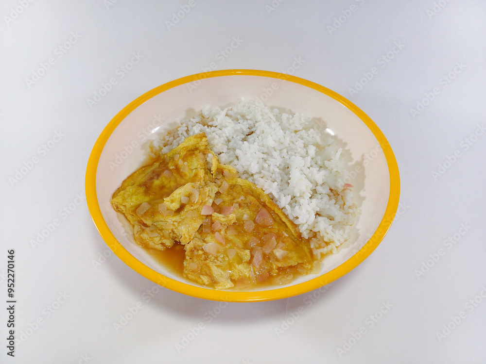Soupy sour omelette cooked in tamarind sour sauce, served alongside rice on a plate with a yellow accent against a white background, creating a vibrant and tangy culinary presentation Soupy sour omelette cooked in tamarind sour sauce, served alongside rice on a plate with a yellow accent against a white background, creating a vibrant and tangy culinary presentation