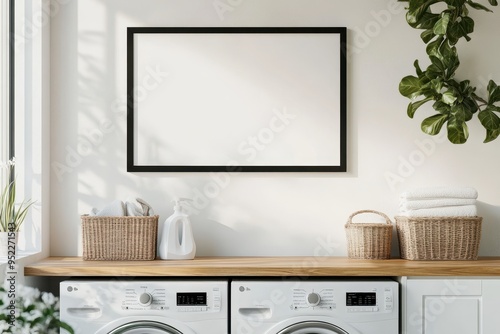 A modern laundry room featuring appliances, storage baskets, and a blank wall for decoration.