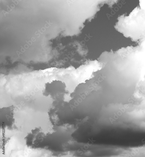 Dramatic cloud formations in a gray sky over an open landscape during an afternoon storm