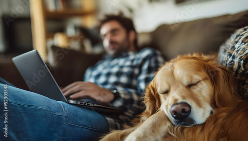 A man works on his laptop while a golden retriever sleeps peacefully beside him, showcasing a relaxed home office atmosphere.