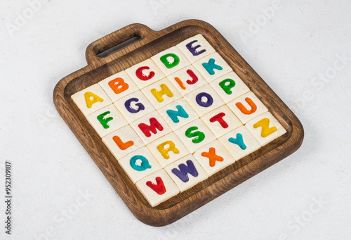 Children English Alphabet. Cookies. Colored English letters. On a wooden board. Close up