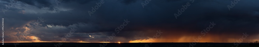 Landscape at sunset. A thunderstorm is approaching the village. Tragic gloomy sky. Panorama. Landscape at sunset. A thunderstorm is approaching the village. Tragic gloomy sky. Panorama.