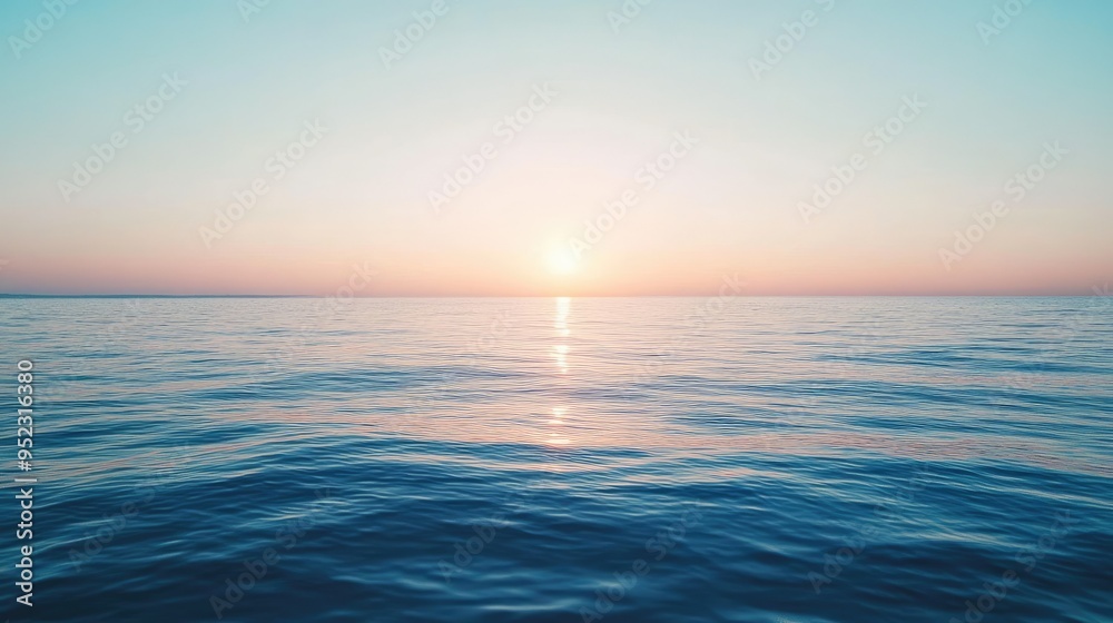 A calm sea with the sun setting in the distance, creating a perfect space for text. No people. A calm sea with the sun setting in the distance, creating a perfect space for text. No people.