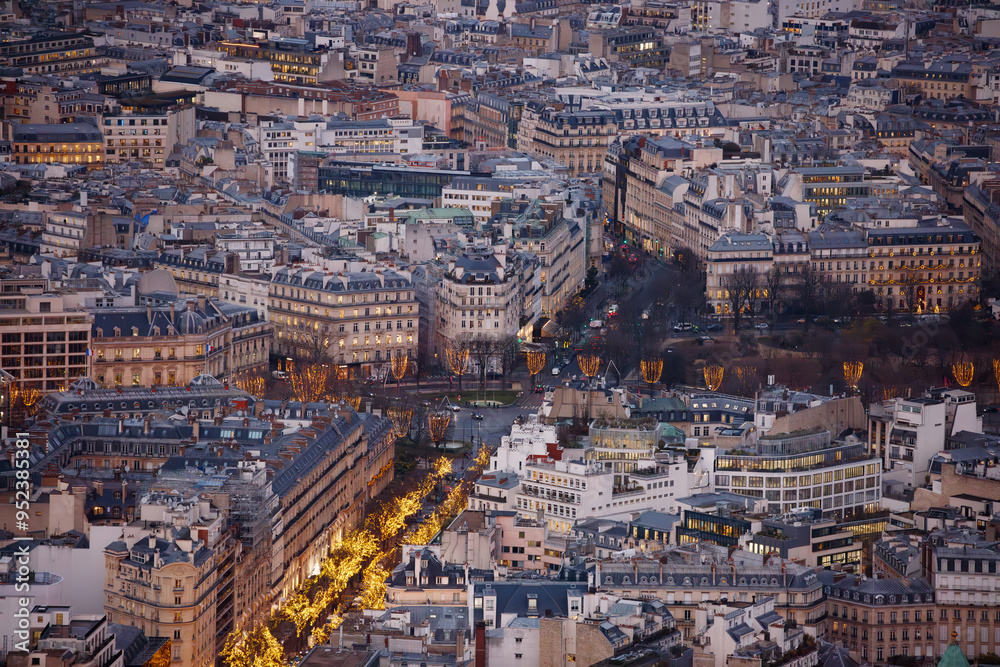 Fototapeta premium Aerial view of a city adorned with lights along central street