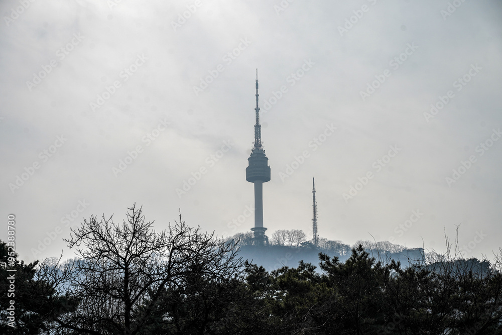 Namsan Tower, a landmark in Seoul, South Korea, with the surrounding cityscape in the background. Namsan Tower, a landmark in Seoul, South Korea, with the surrounding cityscape in the background.