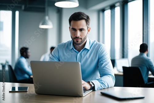 Young Adult Entrepreneur Analyzing Business Data on Laptop at Work Desk