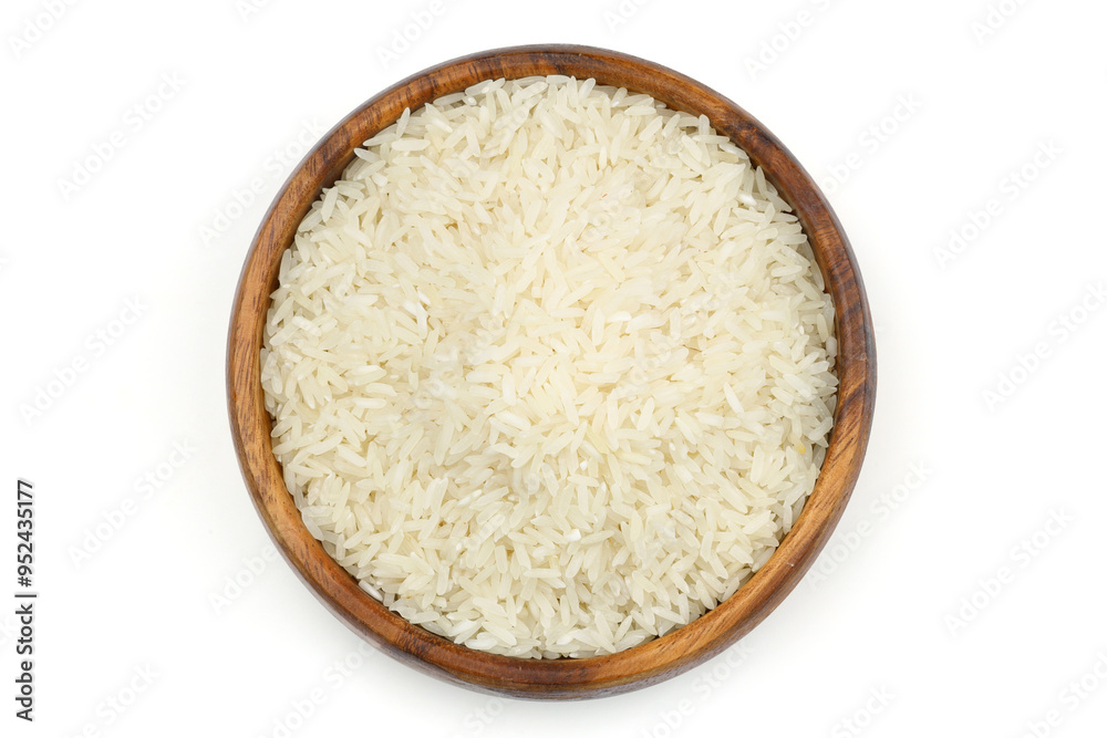 Raw white rice on wooden background. Long uncooked rice in wooden plate. Natural organic food. Traditional Asian cereal culture. Raw white rice on wooden background. Long uncooked rice in wooden plate. Natural organic food. Traditional Asian cereal culture.