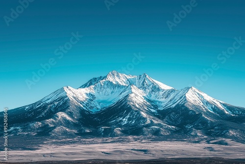 Snow-Capped Mountain Range Under a Clear Blue Sky