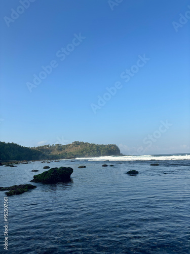 beachscape with wave and rock