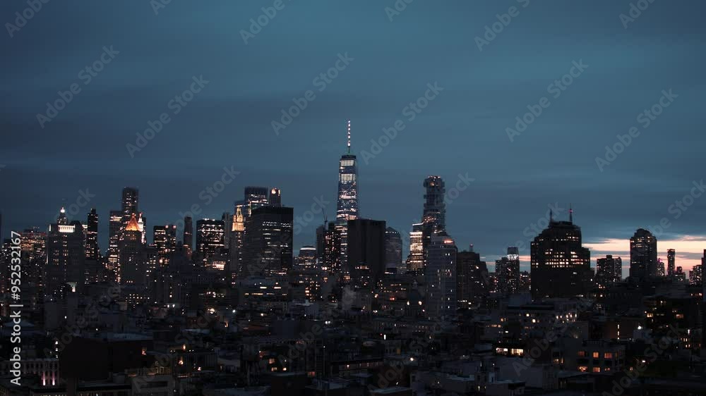 New York timelapse video, shot at sunset to night time. NYC skyline with tall skyscrapers and moving blue sky in the background. Timelapse shot of New York city. 
