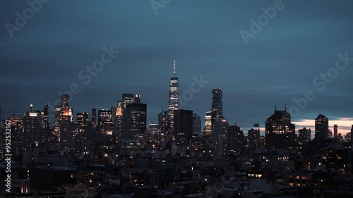 New York timelapse video, shot at sunset to night time. NYC skyline with tall skyscrapers and moving blue sky in the background. Timelapse shot of New York city. 
