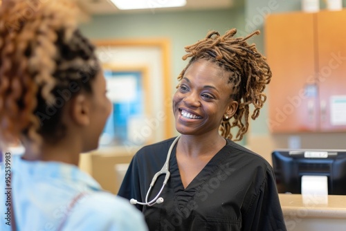 Smiling healthcare professional interacting warmly with a patient at the clinic reception desk