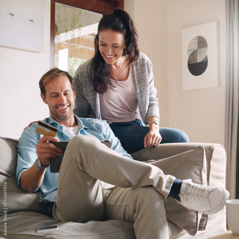 Couple, home and happy on tablet with debit card on sofa for online shopping, payment and saving plan. People, living room and smile on couch for internet banking, budget and investment or finance