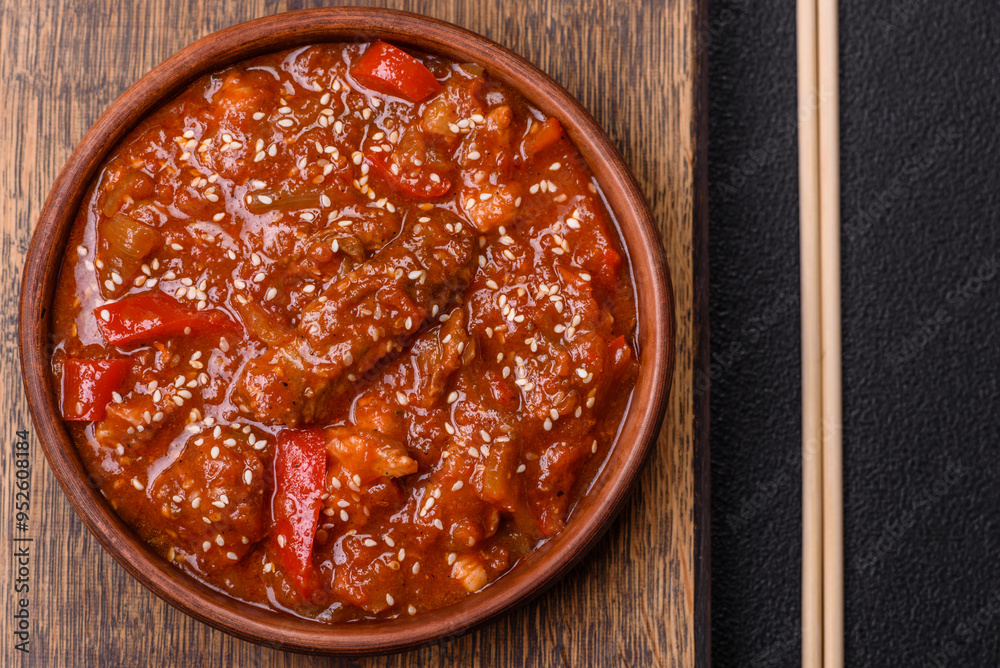 Thai Asian dish with meat, hot pepper, tomato sauce and sesame Thai Asian dish with meat, hot pepper, tomato sauce and sesame