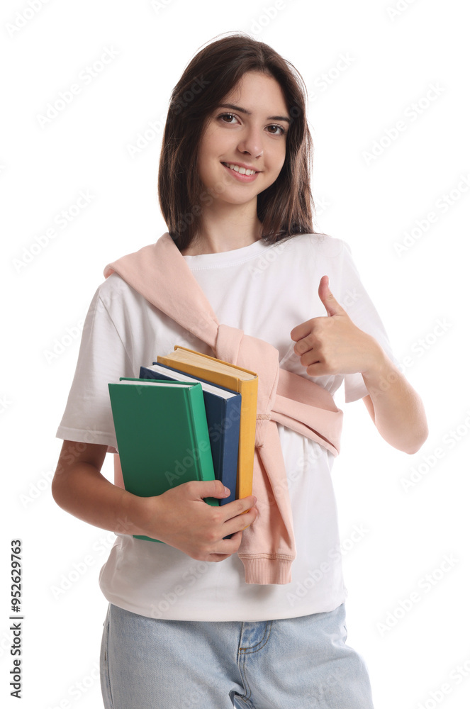 Portrait of cute teenage girl with books showing thumbs up on white background Portrait of cute teenage girl with books showing thumbs up on white background
