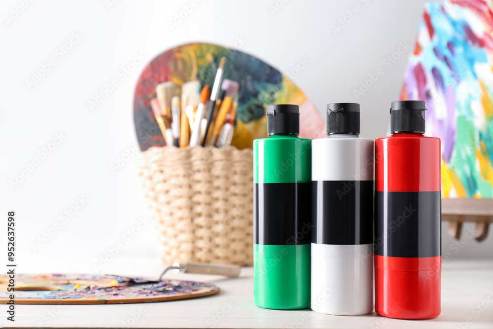 Obraz premium Acrylic paints of different colors, palettes, knife and brushes on wooden table
