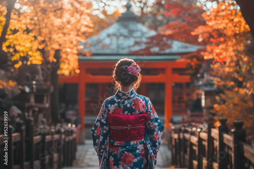 Happy young traveler woman wearing Japanese traditional kimono enjoying beautiful in Autumn season